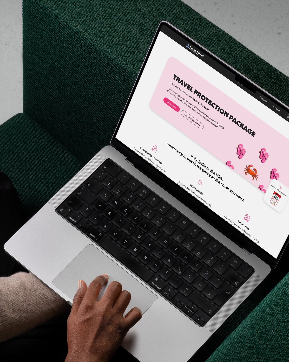 Online insurance service on a laptop, on a dark green sofa
